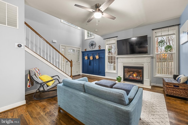 living room featuring dark hardwood / wood-style floors and ceiling fan