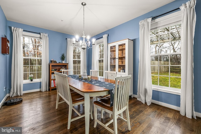 dining room featuring dark hardwood / wood-style floors and an inviting chandelier