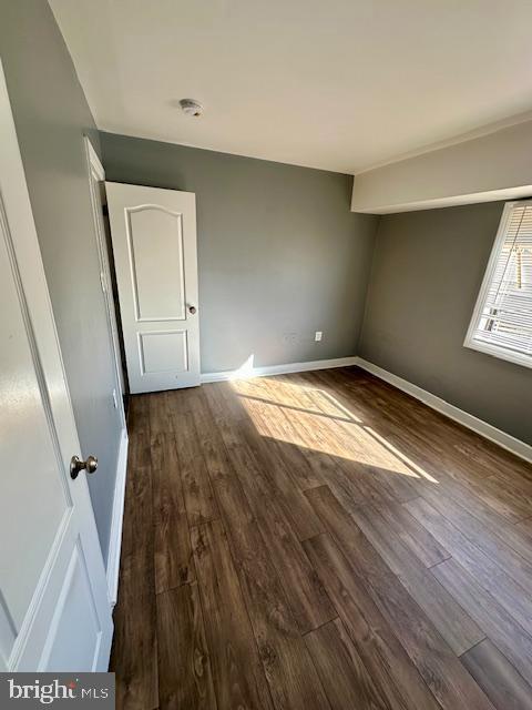 empty room with wood-type flooring