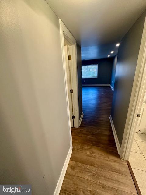 hallway with hardwood / wood-style floors