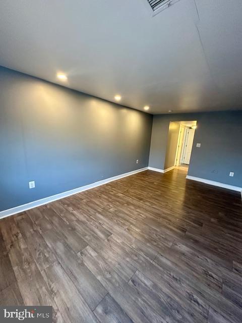 spare room featuring dark wood-type flooring