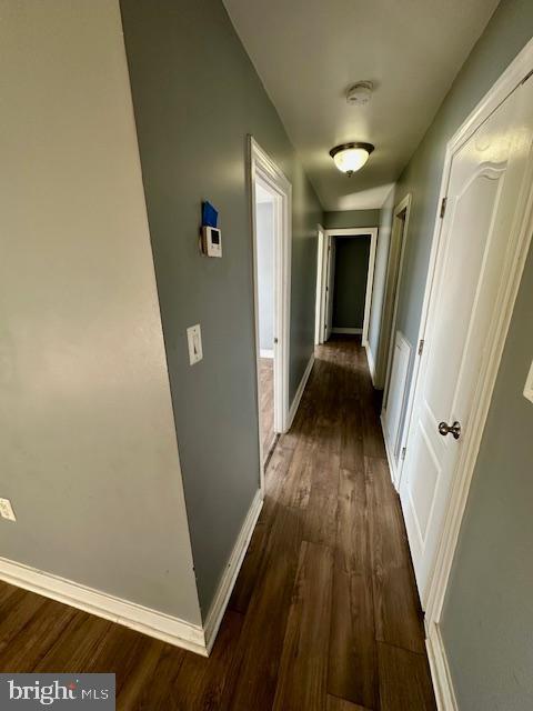 hall with dark wood-type flooring