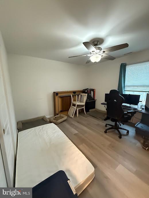 bedroom with ceiling fan and wood finished floors