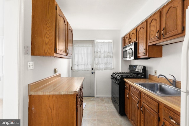 kitchen featuring black range with gas cooktop and sink