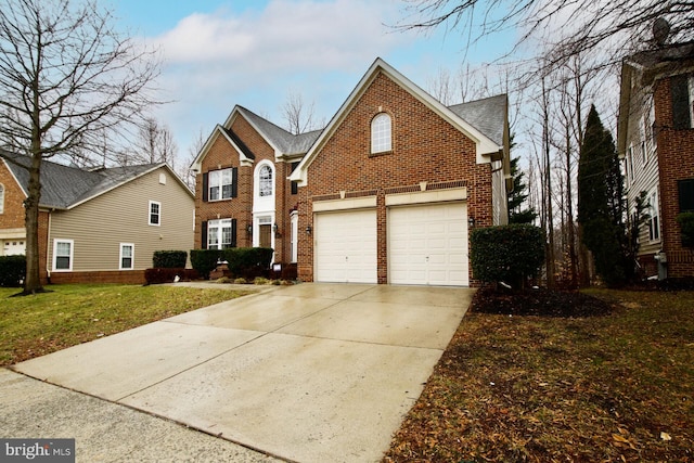 view of property featuring a garage and a front lawn