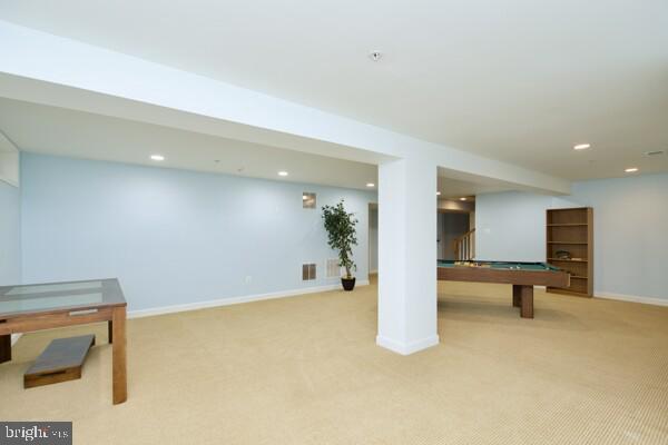 basement featuring light carpet and pool table