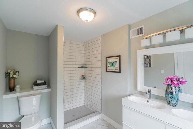 bathroom with toilet, a sink, visible vents, double vanity, and a stall shower