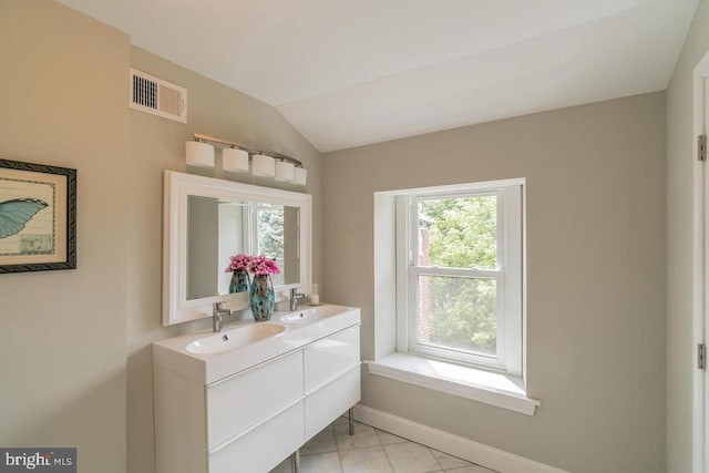 bathroom with a wealth of natural light, visible vents, and a sink