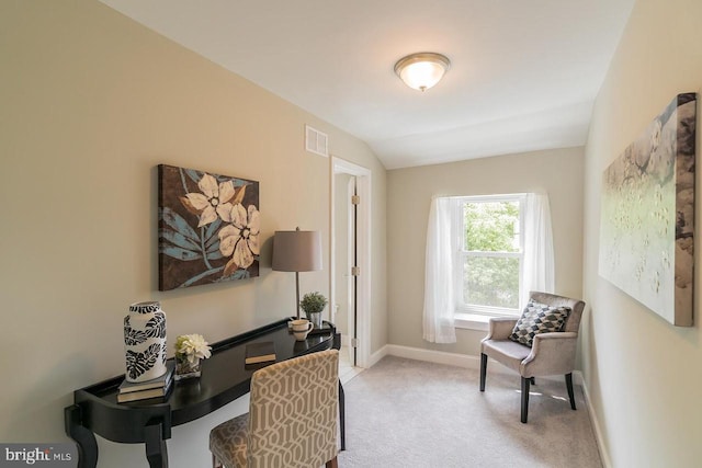 office area featuring vaulted ceiling, baseboards, visible vents, and light colored carpet