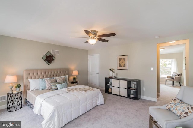 bedroom featuring light carpet, ceiling fan, visible vents, and baseboards