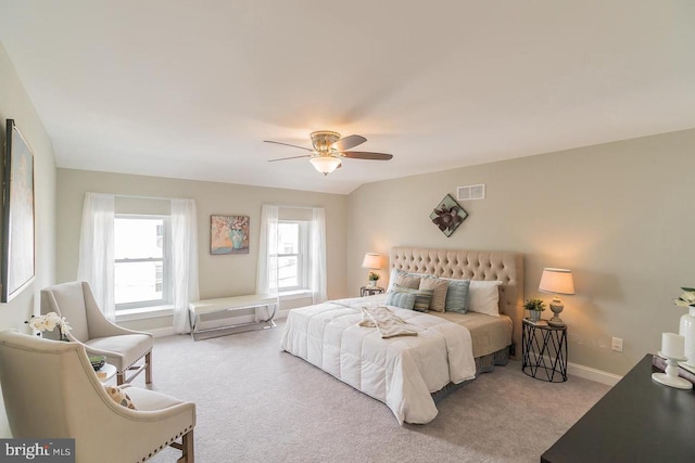 bedroom featuring baseboards, ceiling fan, visible vents, and light colored carpet