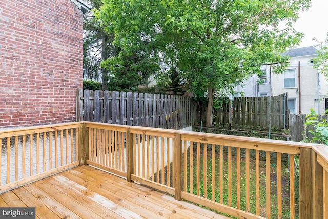 wooden terrace featuring fence