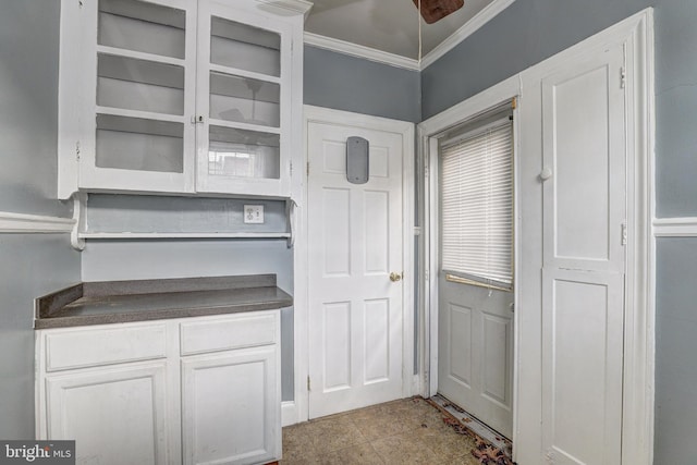 kitchen featuring ornamental molding and white cabinets