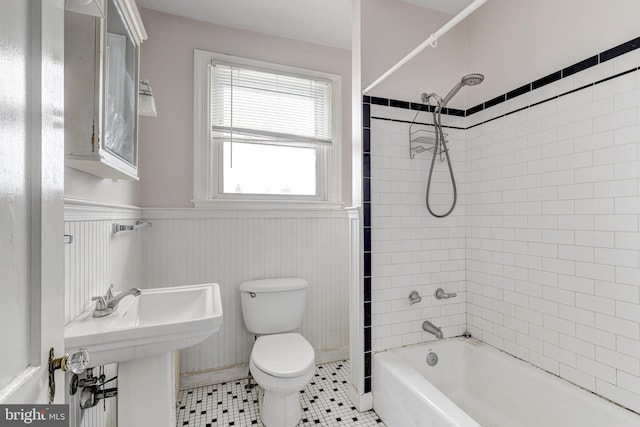 full bathroom featuring tiled shower / bath, tile patterned floors, toilet, and sink