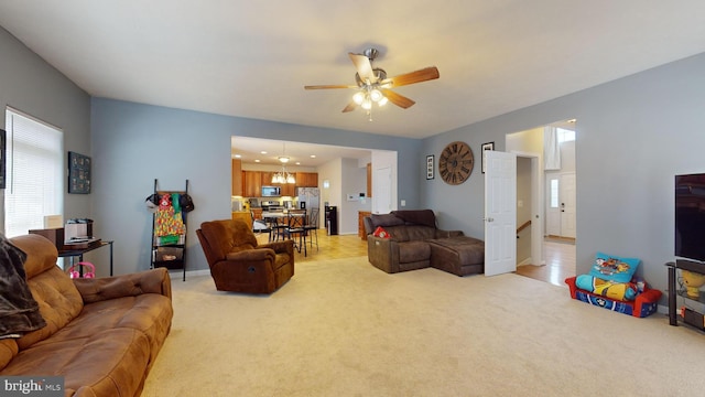 living room featuring light colored carpet and ceiling fan