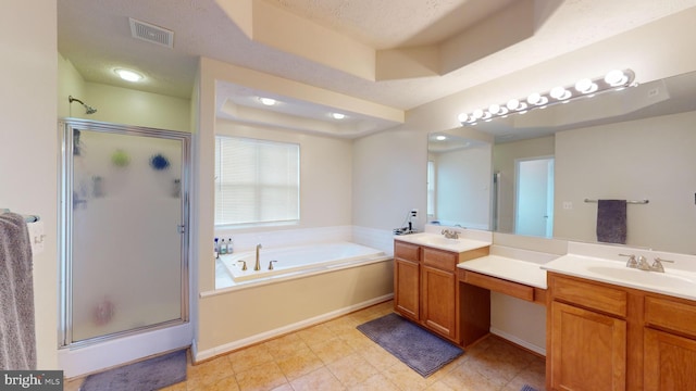 bathroom with plus walk in shower, vanity, a textured ceiling, and a tray ceiling