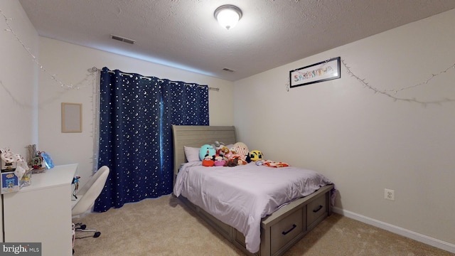 carpeted bedroom featuring a textured ceiling