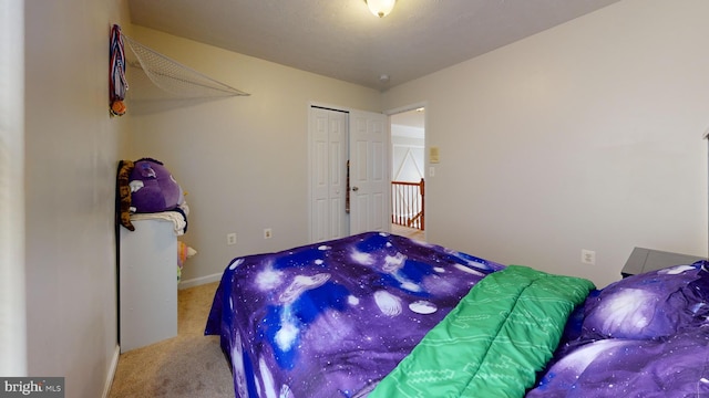 carpeted bedroom featuring a closet