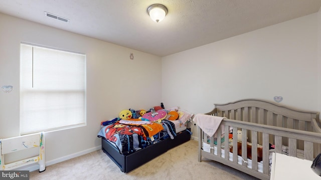 carpeted bedroom with multiple windows