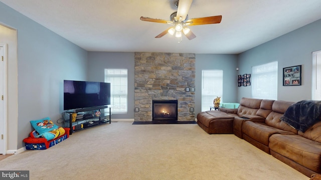 living room featuring ceiling fan, carpet flooring, and a fireplace