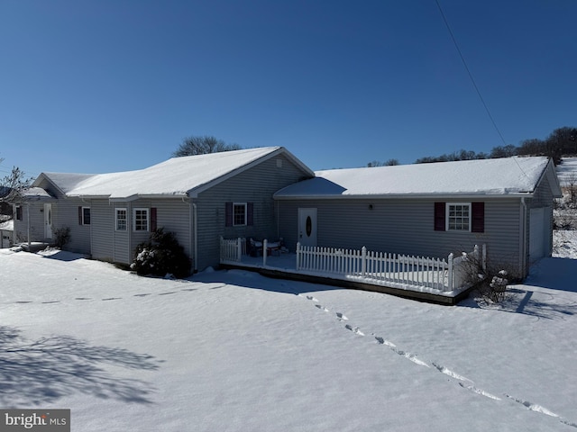 view of snow covered back of property