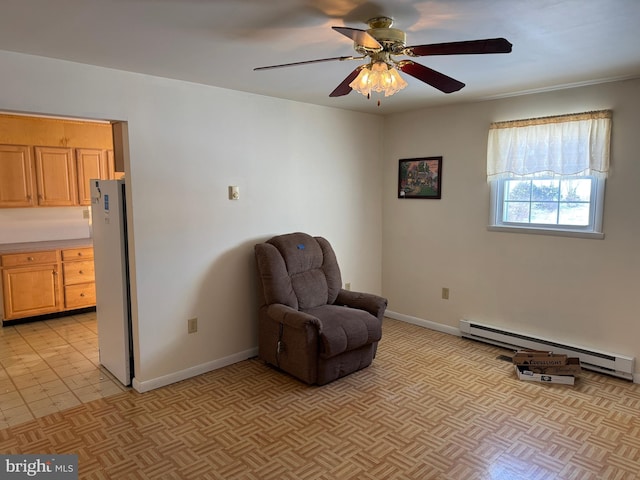 sitting room featuring baseboard heating and ceiling fan