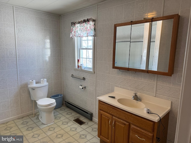 bathroom featuring vanity, tile walls, and toilet