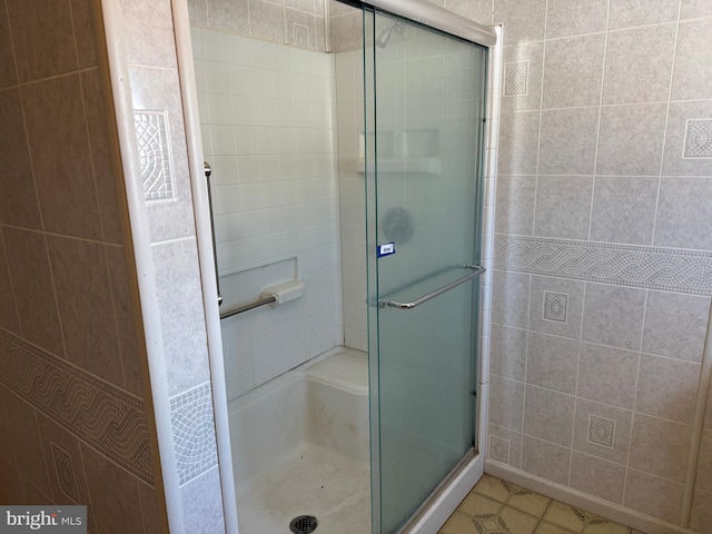 bathroom with a shower with door