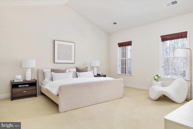 carpeted bedroom with multiple windows and lofted ceiling