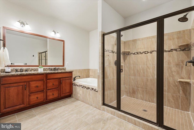 bathroom with vanity and separate shower and tub