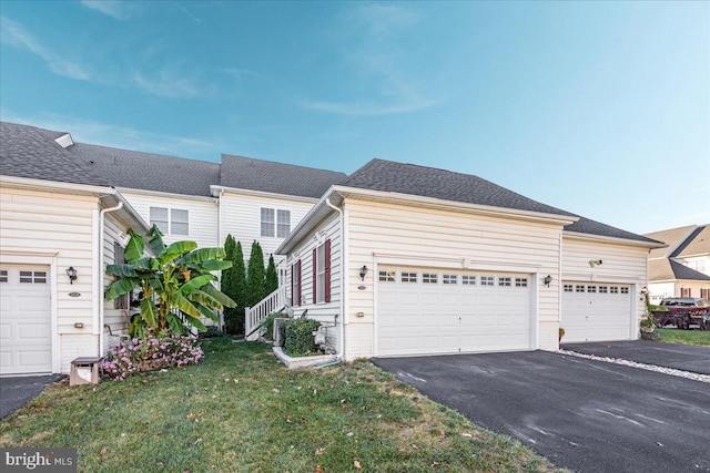 view of front of house featuring a garage and a front lawn