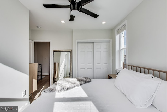 bedroom featuring hardwood / wood-style floors, a closet, and ceiling fan