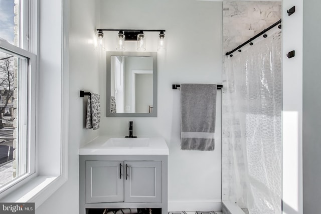 bathroom with walk in shower and vanity