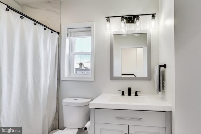 bathroom featuring vanity, a shower with curtain, and toilet