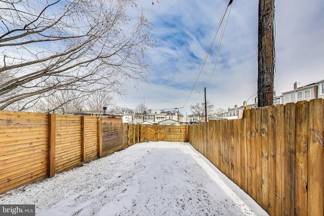 view of yard layered in snow