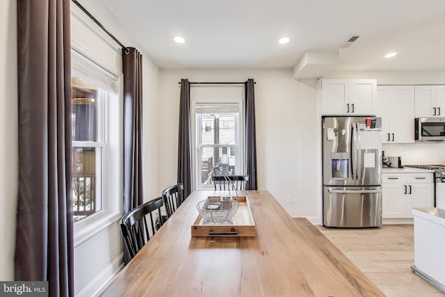 unfurnished dining area with light hardwood / wood-style floors