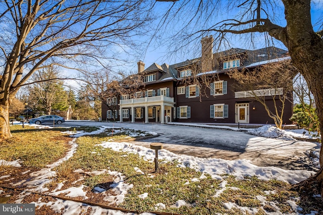 view of snow covered back of property