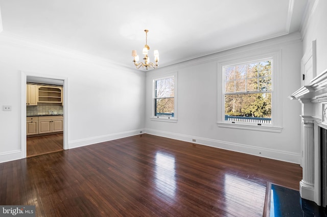 unfurnished living room featuring a notable chandelier, ornamental molding, and hardwood / wood-style floors