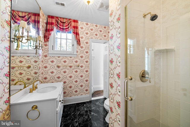 bathroom featuring a shower with door, vanity, and toilet