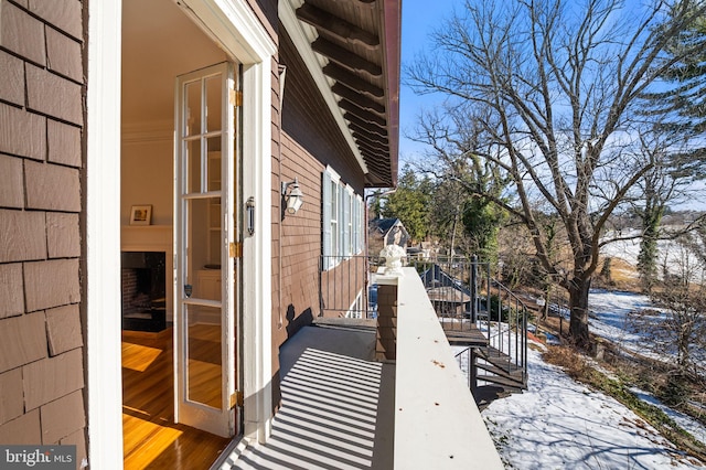 view of snow covered exterior featuring a balcony