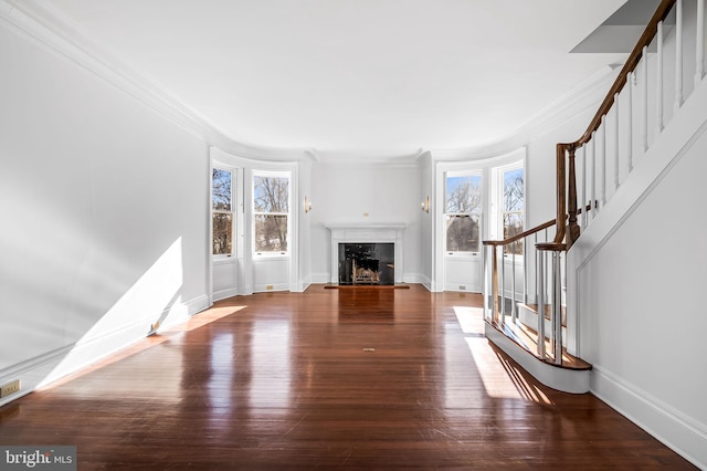 unfurnished living room with crown molding, dark hardwood / wood-style floors, and a high end fireplace