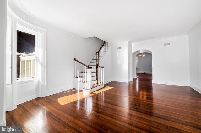 spare room featuring crown molding and dark hardwood / wood-style flooring