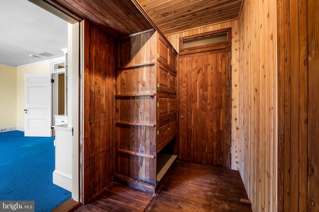 hallway with wooden ceiling, dark hardwood / wood-style floors, and wood walls