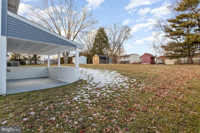 view of yard with a shed and a patio