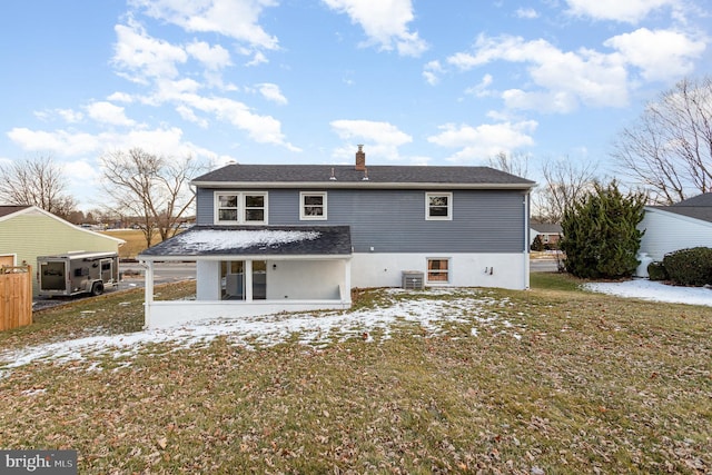 rear view of house featuring a lawn