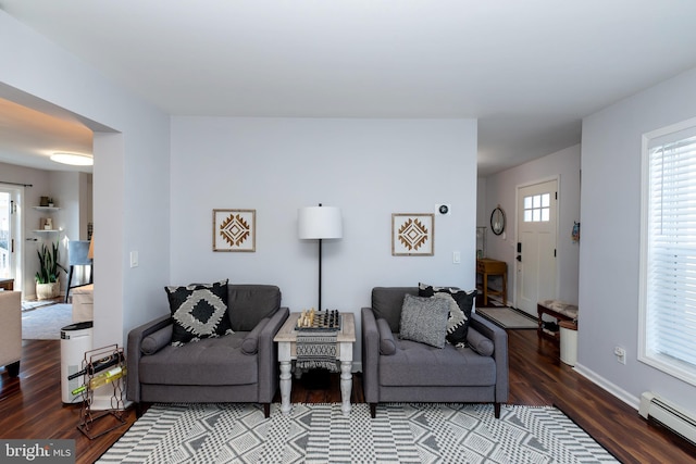 living room featuring a baseboard radiator and hardwood / wood-style floors