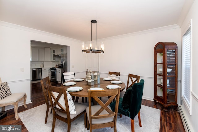 dining area with dark hardwood / wood-style flooring, a baseboard radiator, ornamental molding, and an inviting chandelier