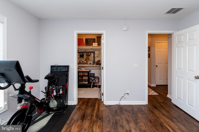 workout area with dark hardwood / wood-style floors