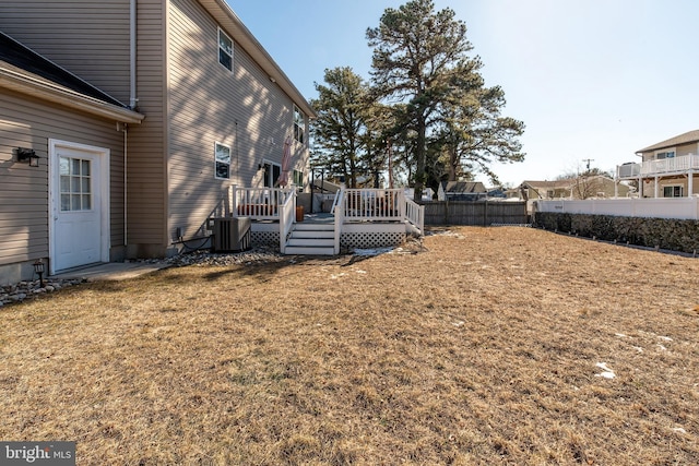 view of yard with a wooden deck and central AC