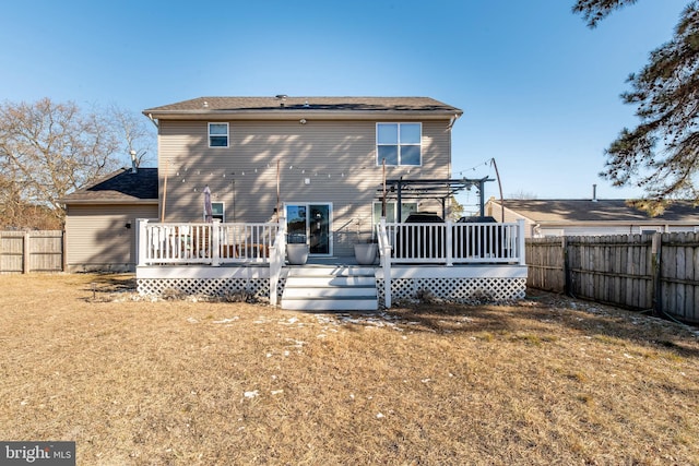 back of house featuring a pergola, a lawn, and a deck